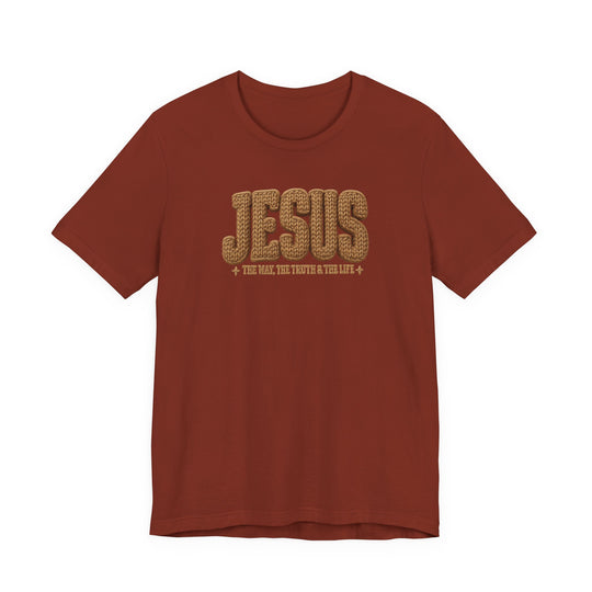 Rust-red Jesus Tee featuring bold, rope-textured JESUS text and the phrase THE WAY, THE TRUTH & THE LIFE below, offering a classic fit and soft cotton feel.