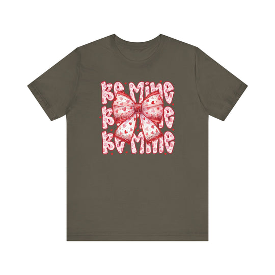 Be Mine Tee in olive-green features a stylized pink bow with heart patterns and BAMING text, exemplifying Faith Family Designs' unique graphic t-shirts.