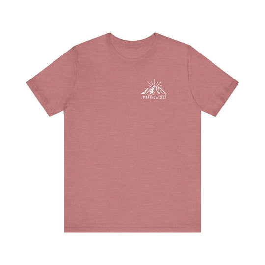 A red t-shirt featuring a mountain and sun logo, embodying the Faith Can Move Mountains Tee from Worlds Worst Tees. Unisex jersey tee with ribbed knit collar, 100% cotton, and tear away label.