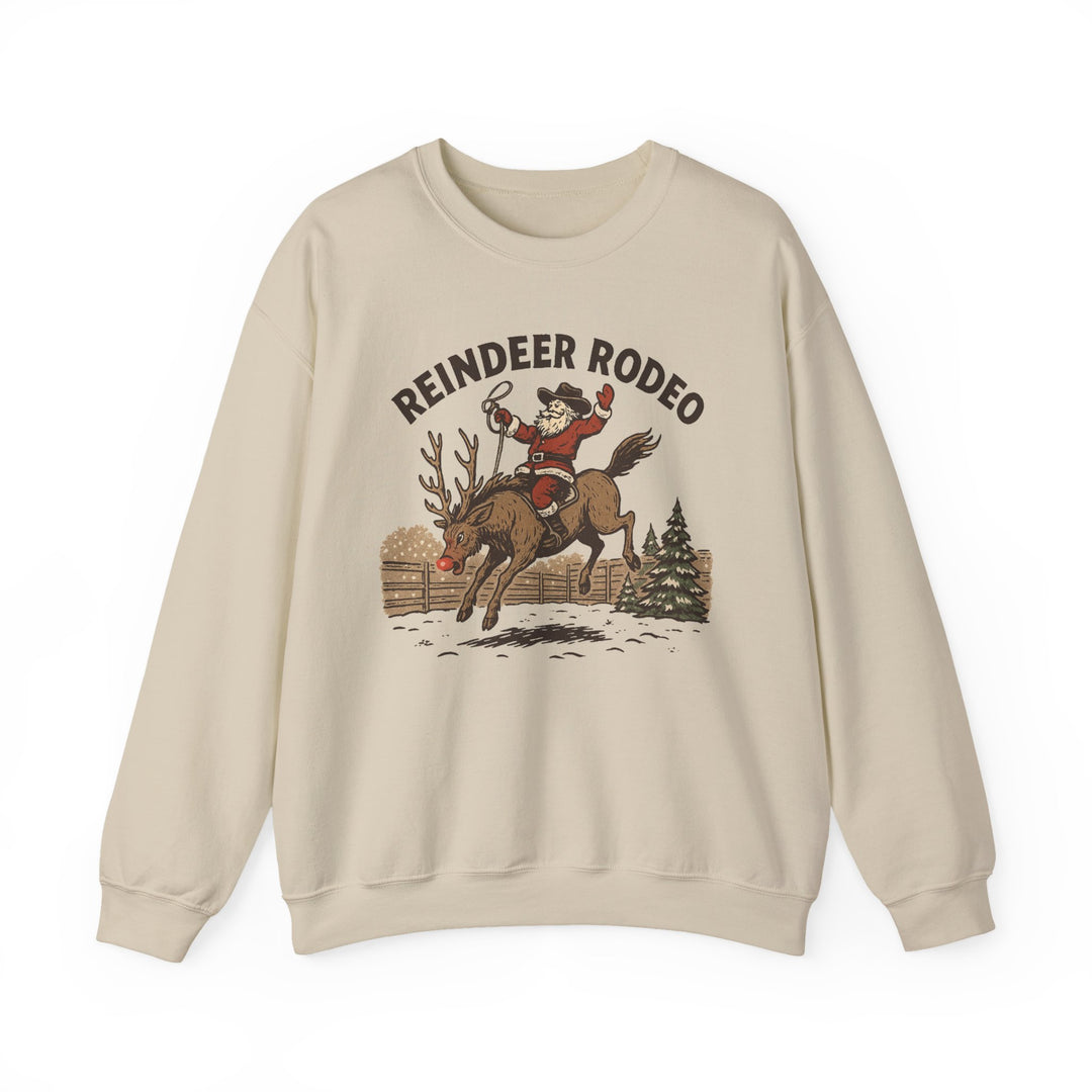 Reindeer Rodeo Crew: Cream crewneck sweatshirt featuring Santa on a bucking reindeer with REINDEER RODEO text, ideal for cozy holiday wear.