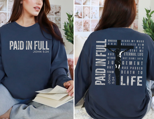 Woman models Paid in Full Long Sleeve Tee, featuring John 5:24 text on front and stylized crucifix with full verse on back, in navy.