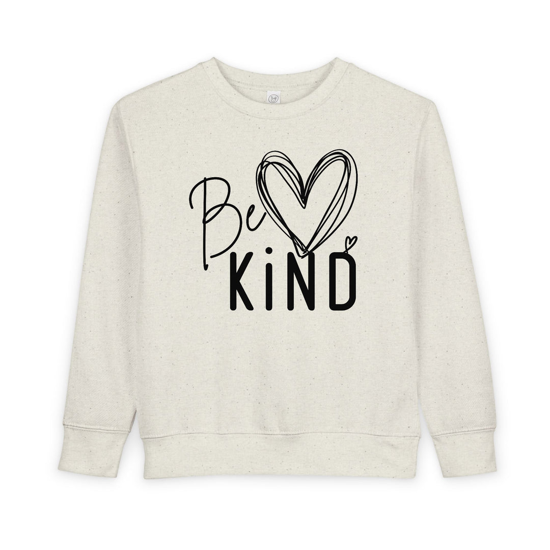 Be Kind Toddler Crew: Cream crewneck sweatshirt featuring 'Be Kind' design with heart graphic, offering warmth and comfort for toddlers.