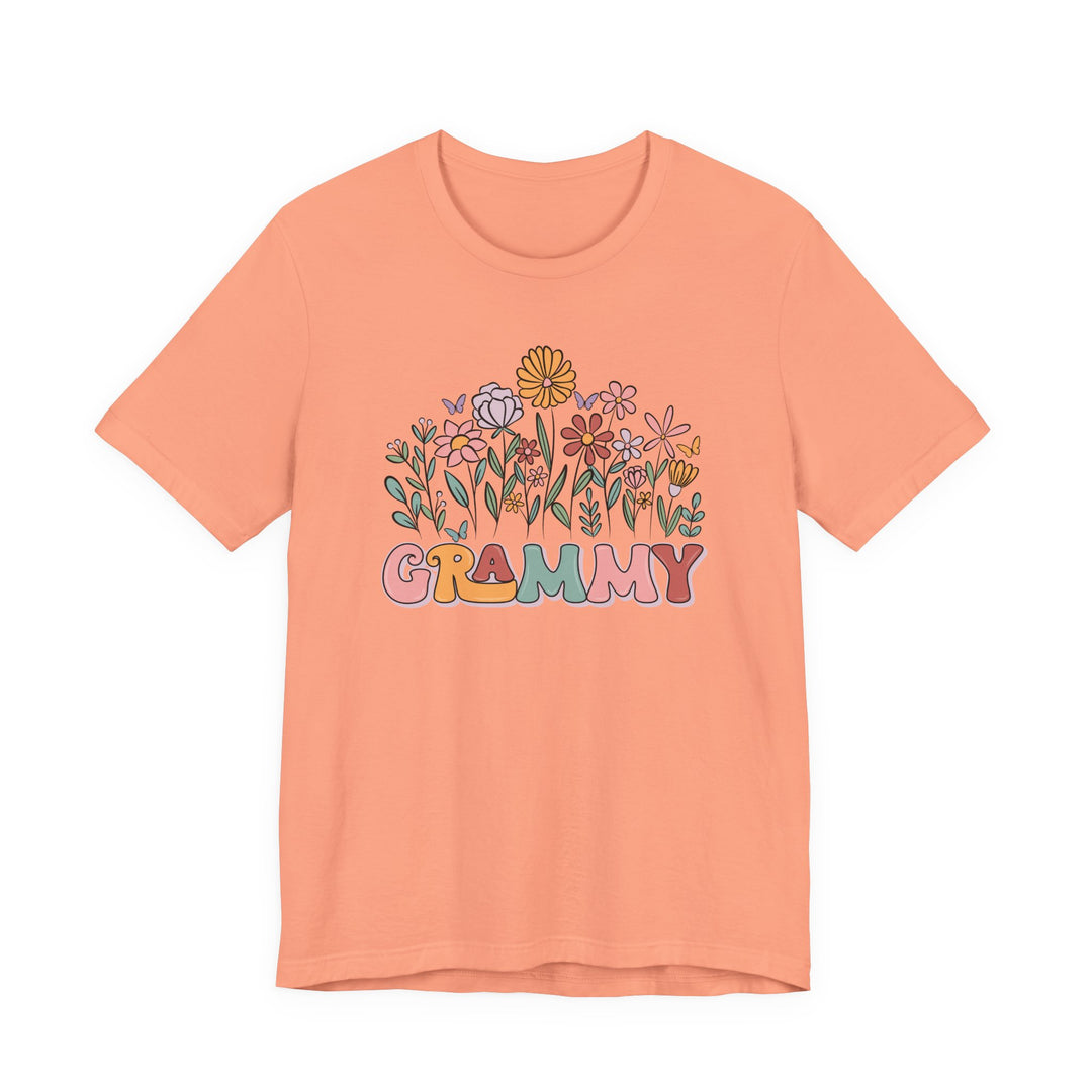 Grammy Flower Tee featuring a whimsical garden and GRAMMY in multicolored bubble letters. Retro-inspired with butterflies, this soft, unisex cotton tee offers a classic fit.