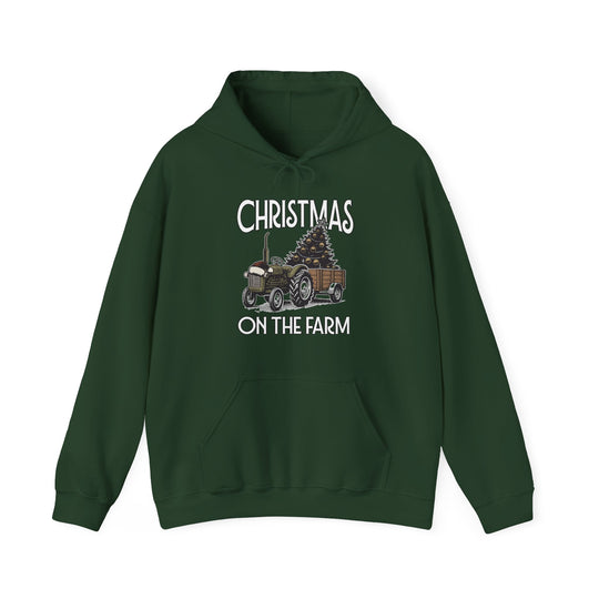 Dark green Christmas at the Farm hoodie featuring a vintage tractor with a Christmas tree graphic and kangaroo pocket, offering warmth and comfort.