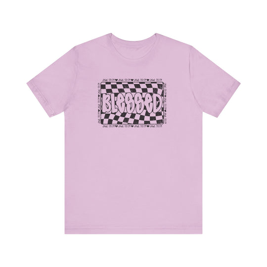Blessed Tee: Pink t-shirt featuring a black and white checkered design, crafted from soft cotton with ribbed knit collars and dual side seams for durability.
