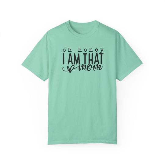 A relaxed fit Oh Honey I'm that Mom Tee, garment-dyed in green with black text. 100% ring-spun cotton, soft-washed for coziness, double-needle stitching for durability, and seamless design for a tubular shape.