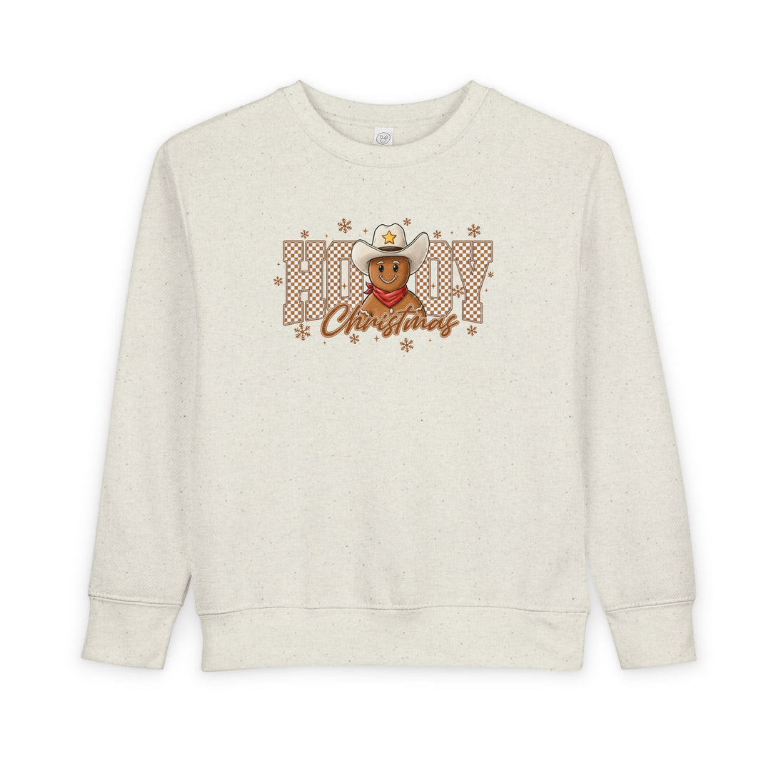 Howdy Christmas Toddler Crewneck features a cowboy gingerbread graphic with snowflakes, blending festive and western themes, ideal for cozy, stylish comfort.