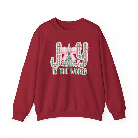 Red crewneck sweatshirt featuring a holiday graphic with cacti spelling JOY and to the world text, made from a cozy cotton-polyester blend.