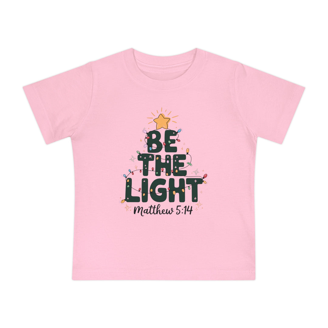 Be the Light Baby Tee featuring a Christmas tree design with BE THE LIGHT, a yellow star, and multi-colored lights, perfect for stylish, comfortable wear.