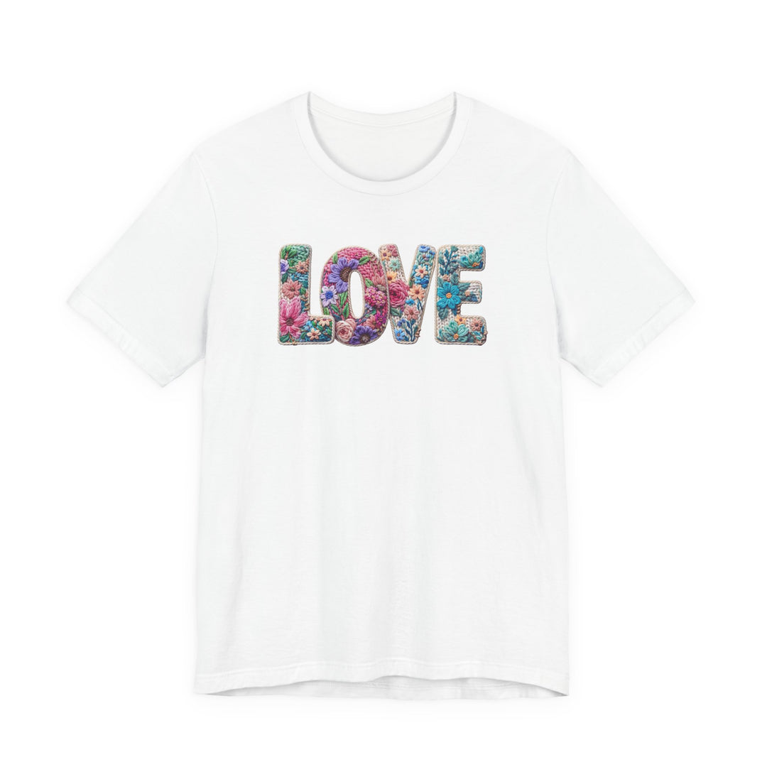 White crew-neck T-shirt with LOVE in floral pattern, offering a soft, retail fit; unisex design from Faith Family Designs.