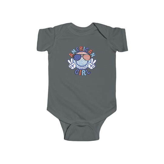 American Girl Onesie featuring a cartoon peace sign and flag on a grey baby bodysuit. 100% cotton, light fabric with ribbed bindings and plastic snaps for easy changing. Ideal for infants.