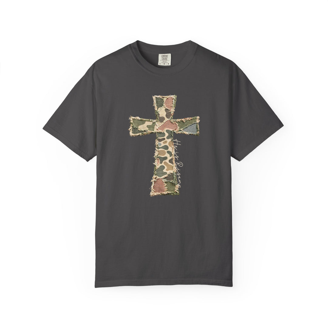 He is Risen Distressed Tee featuring a camouflage patchwork cross and cursive inscription on a dark-charcoal, short-sleeve Comfort Colors T-shirt.