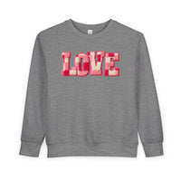 Heather-gray toddler crewneck sweatshirt with LOVE in pink, red, and off-white chenille-style letters. Cozy, durable, and designed for warmth and comfort.
