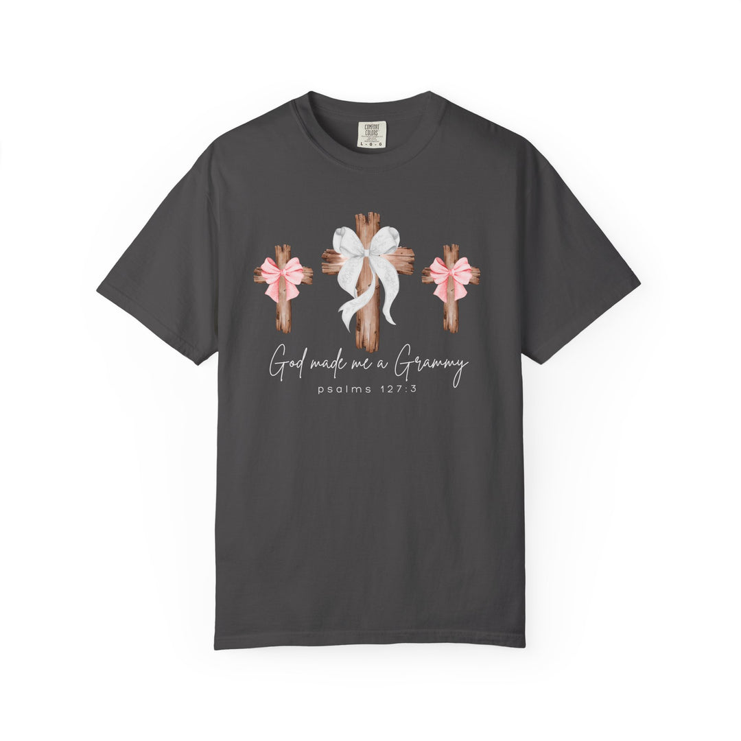 God Made Me a Grammy Tee featuring three rustic wooden crosses with bows, central white, side pink, and script text, emphasizing faith and family connection.