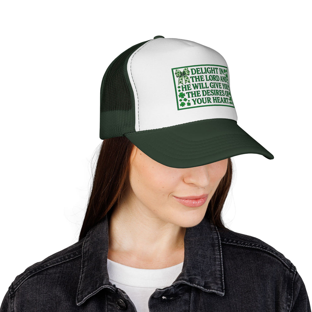 Woman wearing Delight in the Lord Trucker Cap with a black denim jacket. The cap features green lettering with shamrock motifs on a white front panel.