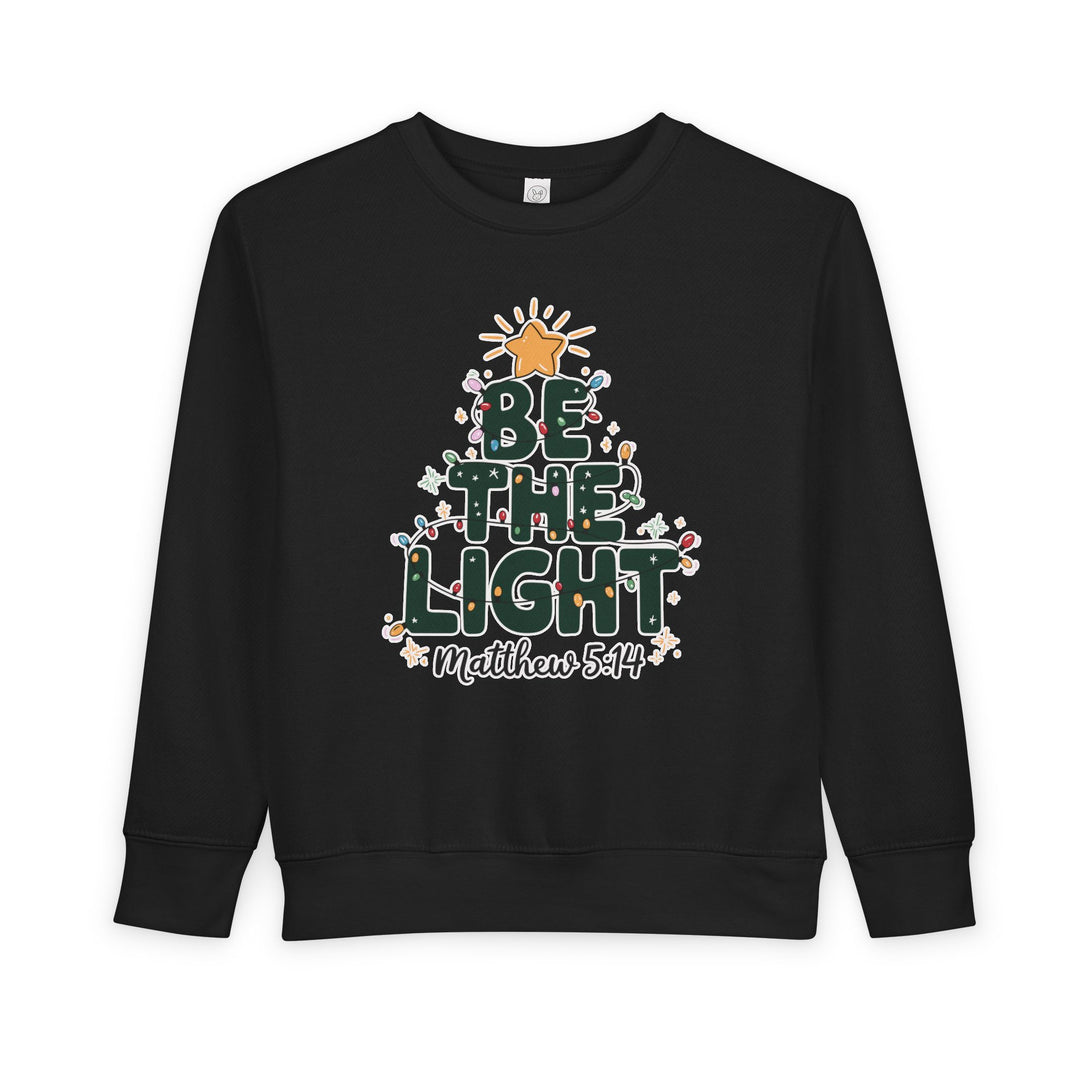 Be the Light Toddler Crew sweatshirt with festive tree graphic, Bible verse Matthew 5:14, crafted from soft, durable cotton-poly blend for comfort and style.
