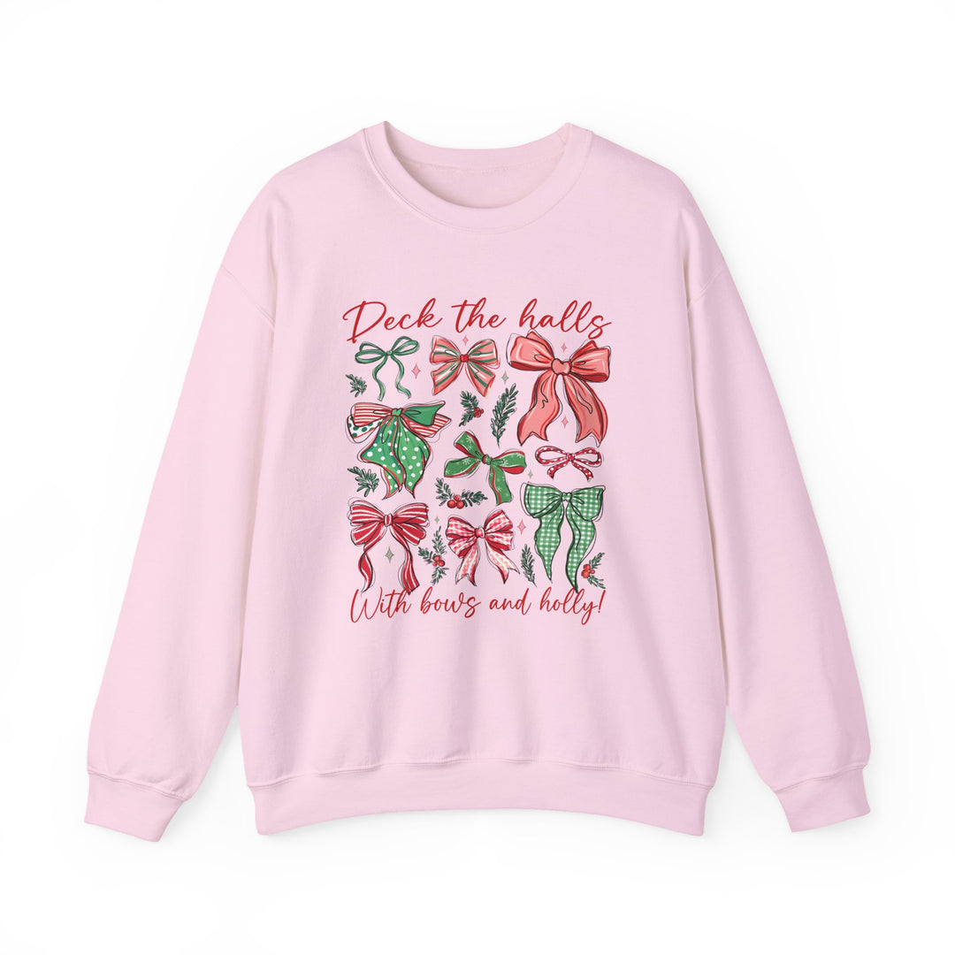Light-pink crewneck sweatshirt with Deck the Halls text, featuring festive bows and holly graphics on the front, ideal for cozy, holiday-themed wear.