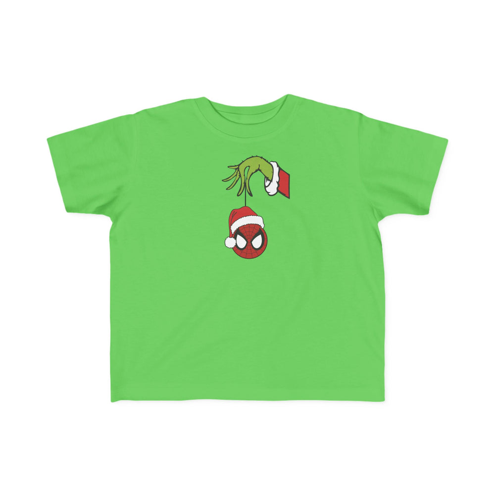 Spider Ball Christmas Toddler Tee features the Grinch's hand holding a Spider-Man mask ornament with a Santa hat, ideal for toddlers’ holiday adventures.