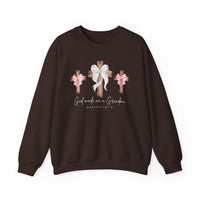 God Made Me a Grandma Crew sweatshirt with wooden cross design and bows, featuring a cursive religious phrase, offering comfort with a cotton-poly blend.