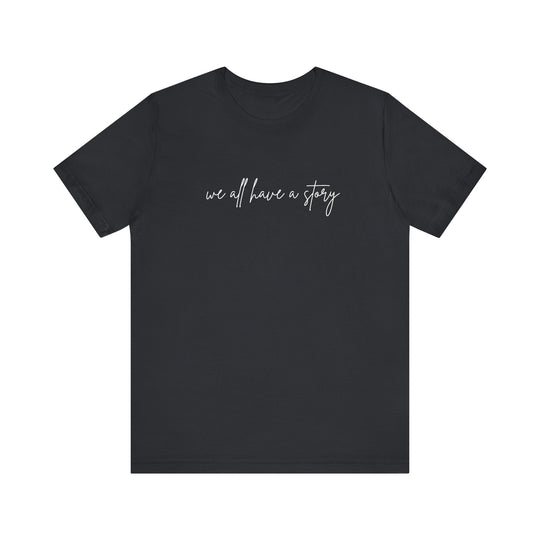 We all have a Story Tee: Black t-shirt with bold white text, featuring a classic unisex fit, known for its soft cotton and durable structure.