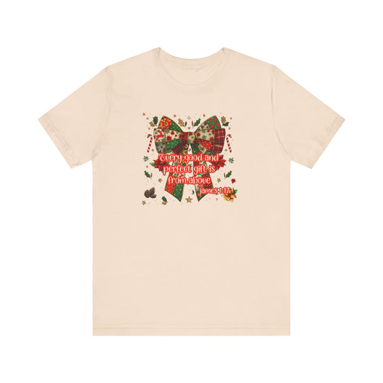 Gift from Above Tee featuring a patchwork Christmas bow design with festive elements and scripture quote, offering a soft, classic fit.
