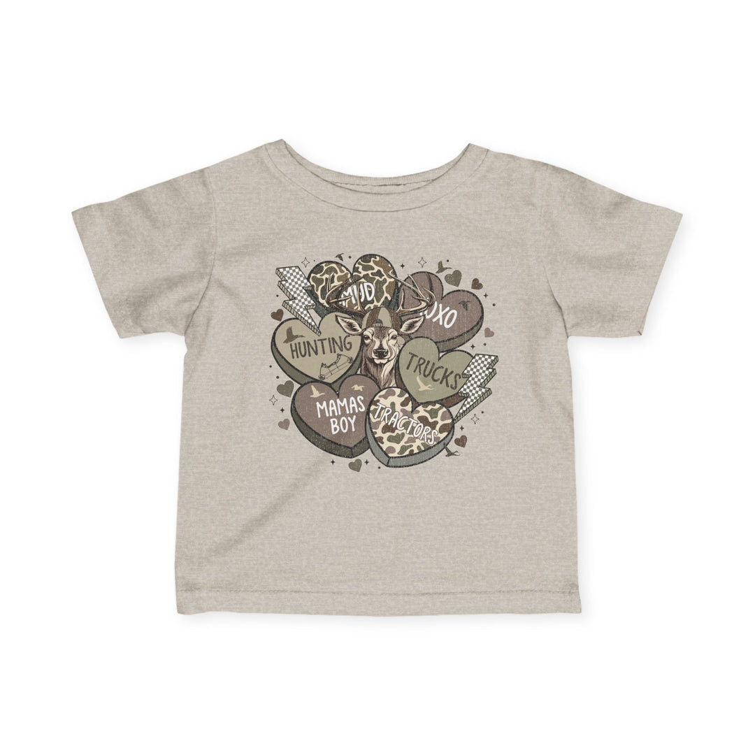 Boy Valentine Baby Tee featuring rustic hearts, lightning bolts, and a deer graphic. Includes phrases like MUD and XOXO, in a playful, outdoorsy style.