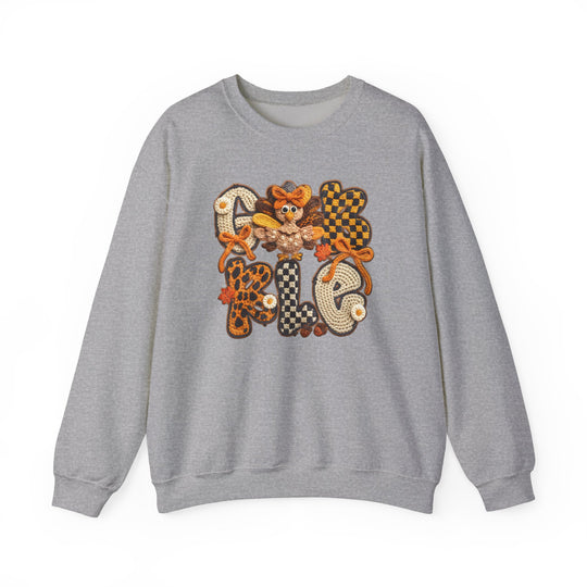 Heather-gray Gobble Crew sweatshirt featuring a crochet-style applique with GOBBLE in fall colors and a cartoon turkey, perfect for cozy autumn wear.