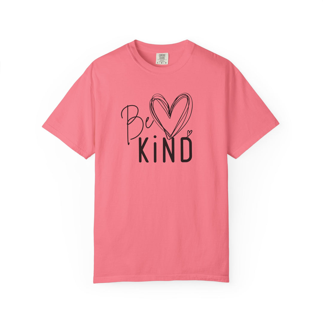 Solid-pink Be Kind Tee featuring a hand-drawn heart and bold text on the chest, designed for comfort with a relaxed fit.