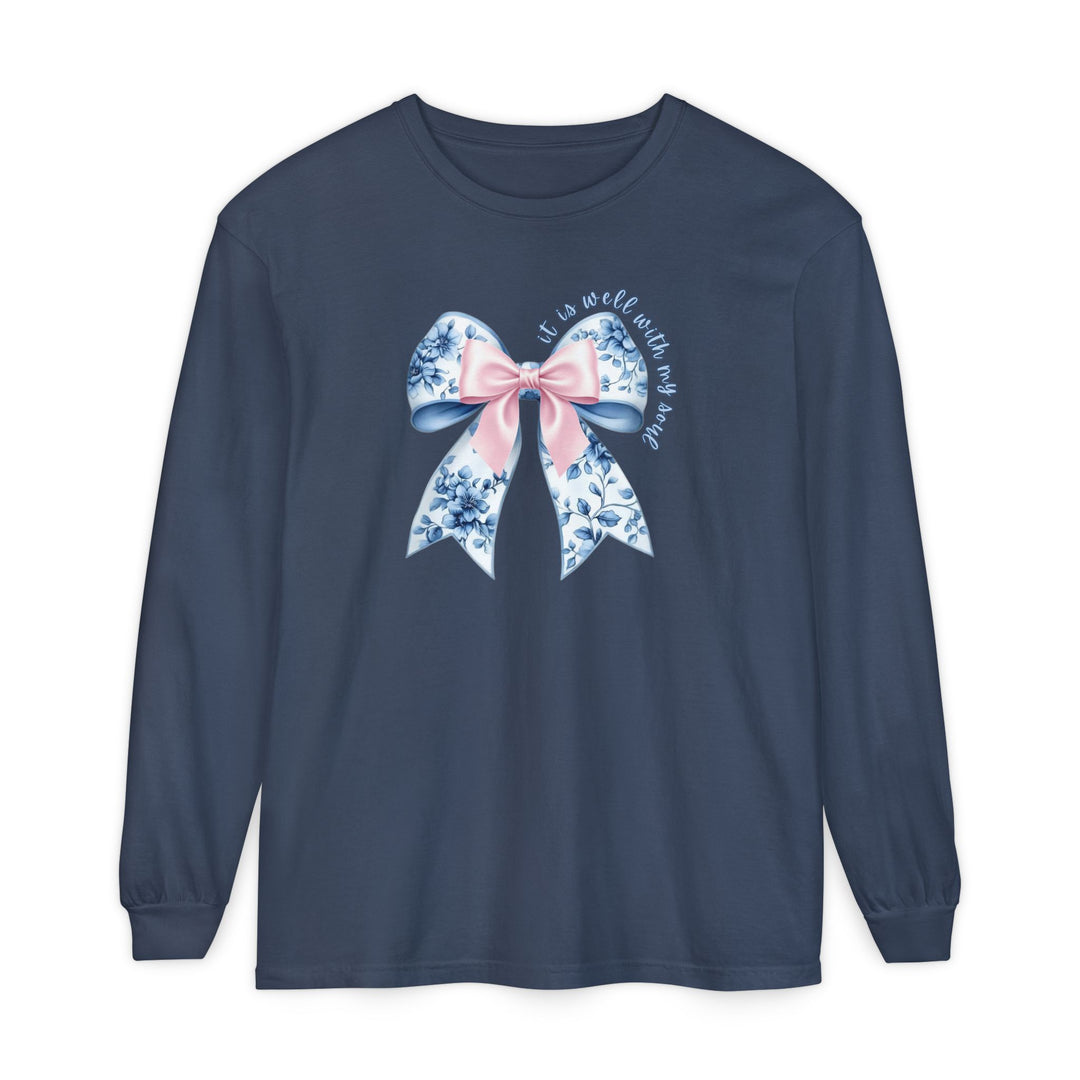Navy-blue long-sleeve tee with floral bow and it is well with my soul text, offering comfort and style from Faith Family Designs.