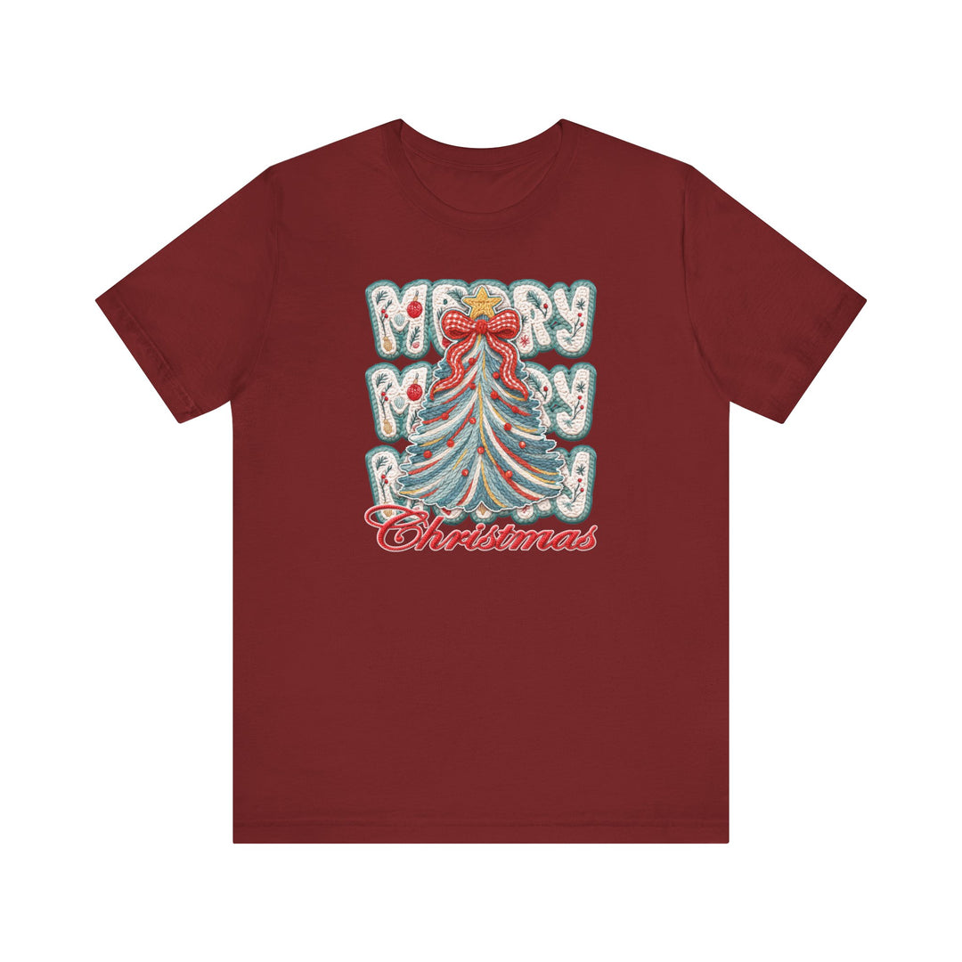 Merry Christmas Tree Tee featuring a festive embroidered-style Christmas tree graphic with ornaments and Merry Merry Christmas text on a burgundy short-sleeve T-shirt.