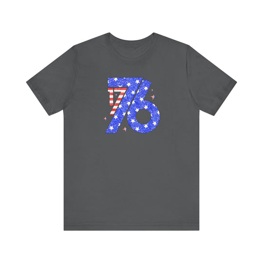 A grey 1776 Tee with a number and stars, made of soft cotton. Unisex jersey shirt with ribbed knit collars, taping on shoulders, and tear away label. Retail fit, 100% Airlume combed and ringspun cotton.