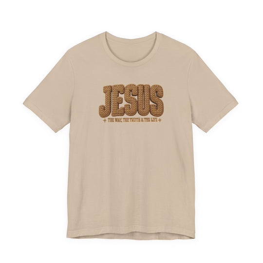 Light beige T-shirt with JESUS in rope-style lettering and The Way, The Truth & The Life beneath, featuring decorative crosses.