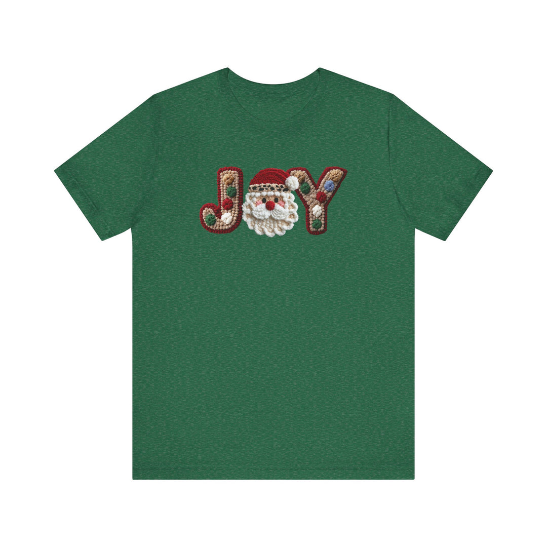 Joy Tee featuring a festive JOY design with a hooked-rug style and a Santa-face graphic, on a soft, unisex green cotton T-shirt.