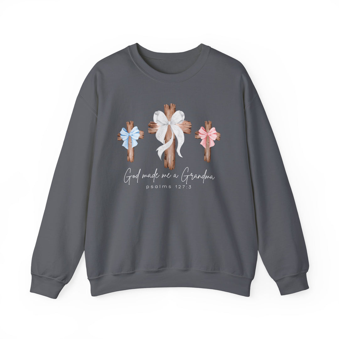 Dark-gray sweatshirt featuring three wooden crosses with bows; center cross has a white bow, flanked by blue and pink bows, with God Made Me a Grandma text.