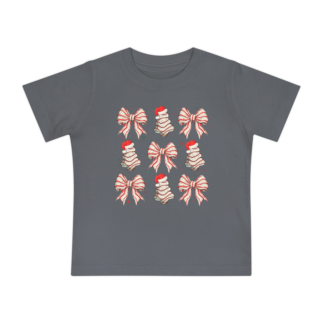 Cookies and Bows Baby Tee: Dark-gray kids' T-shirt featuring a festive 3x3 grid of Christmas-themed icons, candy-cane bows, and meringue tree shapes with Santa hats.
