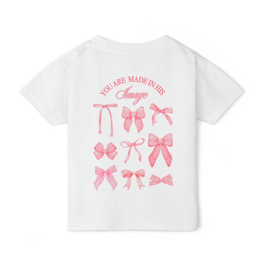 Heavy Cotton™ Toddler T-shirt featuring back print of nine pink bows and YOU ARE MADE IN HIS Image. Ideal for comfort and style.