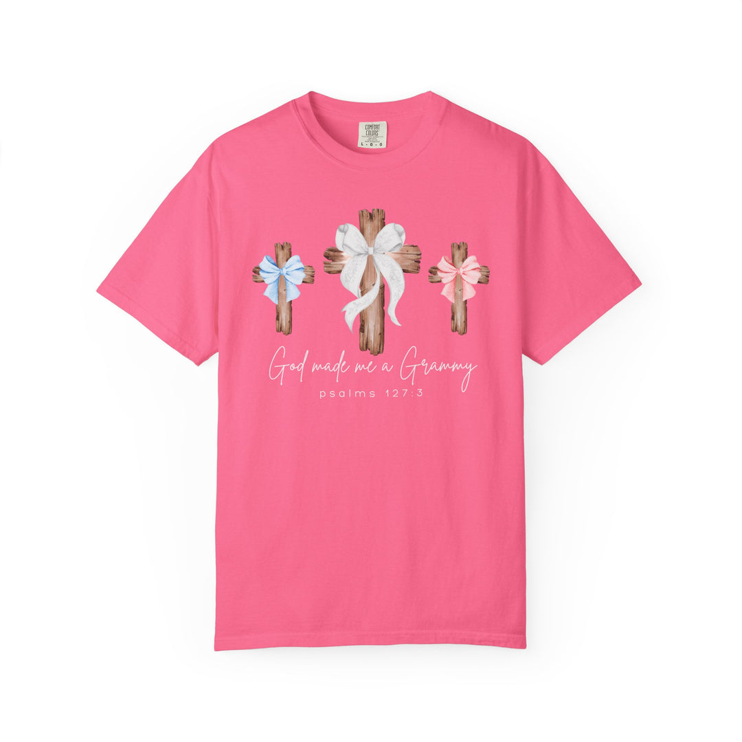Bright pink God Made Me a Grammy T-shirt featuring three wooden crosses with bows, script lettering, and Psalms 127:3 verse, by Faith Family Designs.