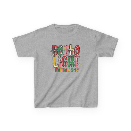 Heather-gray kids' tee with “Be the Light” slogan in festive lettering, featuring small Christmas bulbs and “Matthew 5:14” below. Perfect for everyday wear.