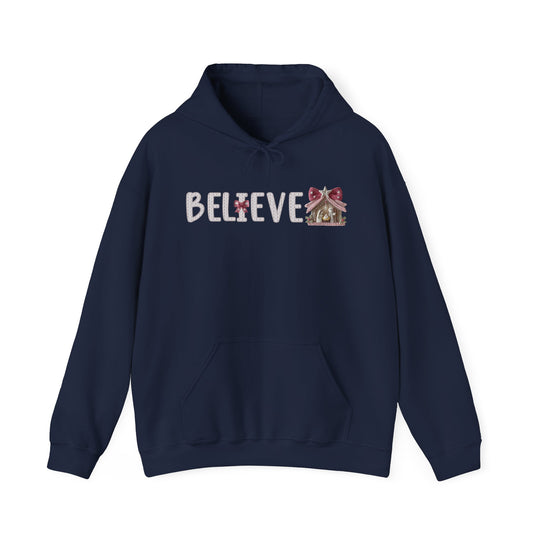 Navy-blue Believe hoodie featuring a Christmas-themed graphic with a Nativity scene, designed for warmth and comfort with a spacious kangaroo pocket.