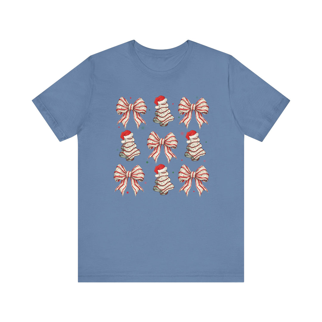 Cookies and Bows Tee: Light-blue T-shirt featuring holiday motifs of bows and cookie Christmas trees in a 3x3 grid, with stars scattered around. Classic fit.