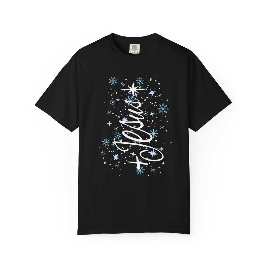 Jesus Tree Tee features Jolly in white script with festive snowflakes on a black short-sleeve Comfort Colors t-shirt, embodying wintry charm and comfort.