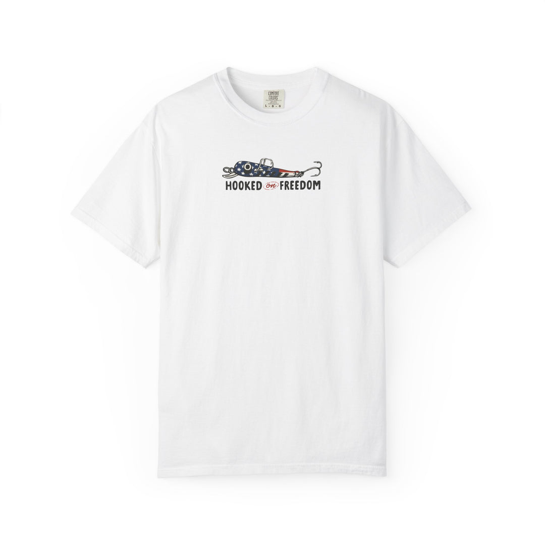 Hooked on Freedom Tee: White short-sleeve t-shirt featuring a stars-and-stripes fishing hook graphic with the slogan 'HOOKED on FREEDOM' on the chest.