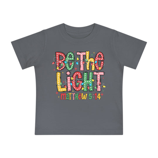 Children's slate-gray Be the Light T-shirt with colorful lettering and Christmas lights, featuring Matthew 5:14. Soft, shrink-resistant, 100% cotton for comfort and durability.