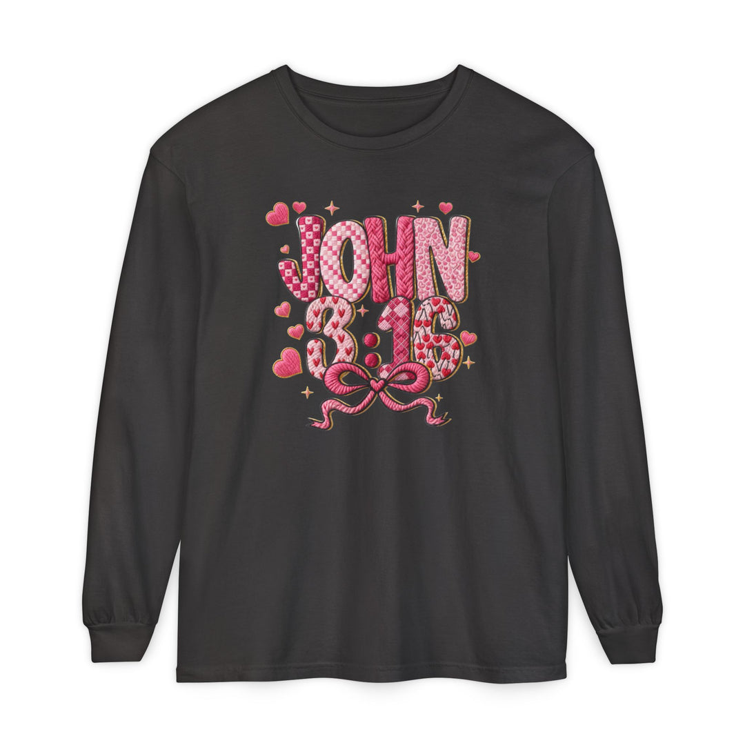 Black long-sleeve T-shirt featuring John 3:16 in pink and red heart patterns with a bow, made from soft ring-spun cotton for comfort.