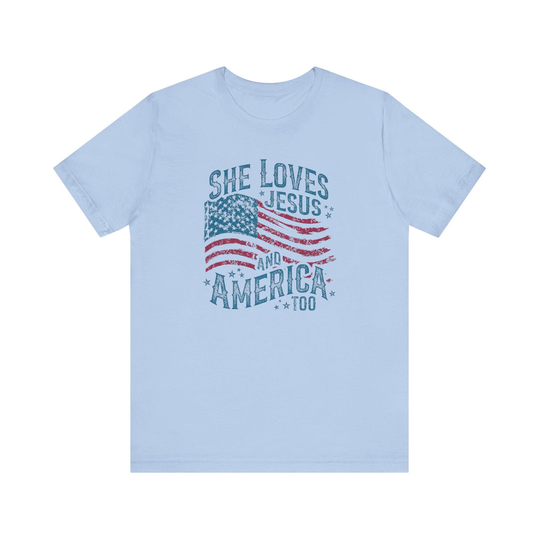 Light-blue T-shirt featuring a distressed American flag graphic with text: She Loves Jesus and America Too, epitomizing Faith Family Designs' unique and patriotic style.