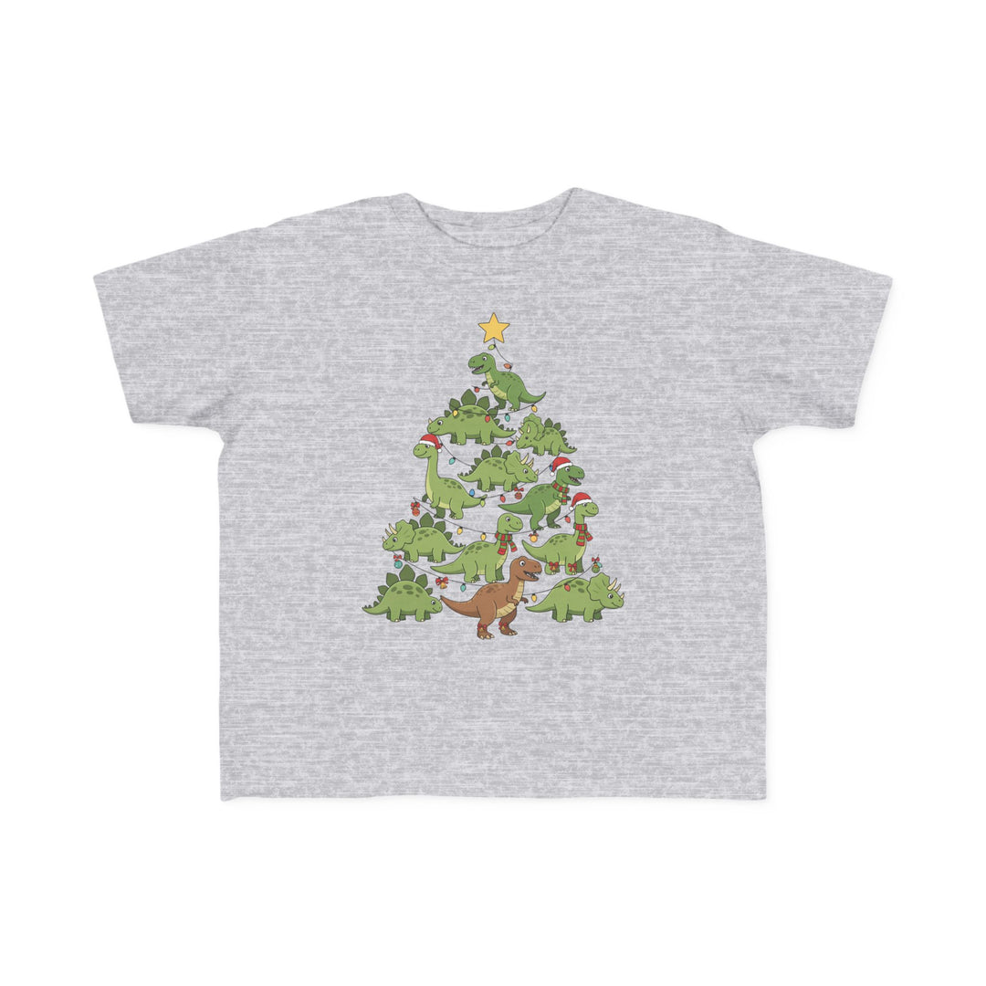 Dino Tree Toddler Tee: Light-gray T-shirt featuring cartoon dinosaurs forming a Christmas tree, adorned with lights, ornaments, Santa hats, and topped with a star.