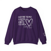 Fighting a Battle Crew: Purple sweatshirt with inspiring white graphic text, Everyone you meet is fighting a battle, hand-drawn heart, and Be Kind on the sleeve.