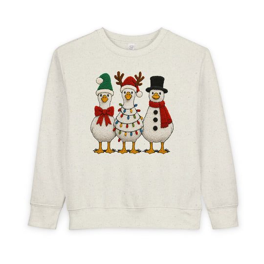 Christmas Geese Toddler Crew: Light-cream sweatshirt with festive cartoon geese—elf, Christmas tree, snowman—providing warmth and comfort for toddlers.