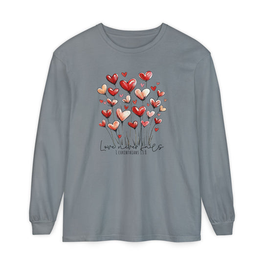 Heather-gray Love Never Fails long-sleeve tee with red and pink heart-shaped flowers and a scripture reference, made of soft, 100% ring-spun cotton.
