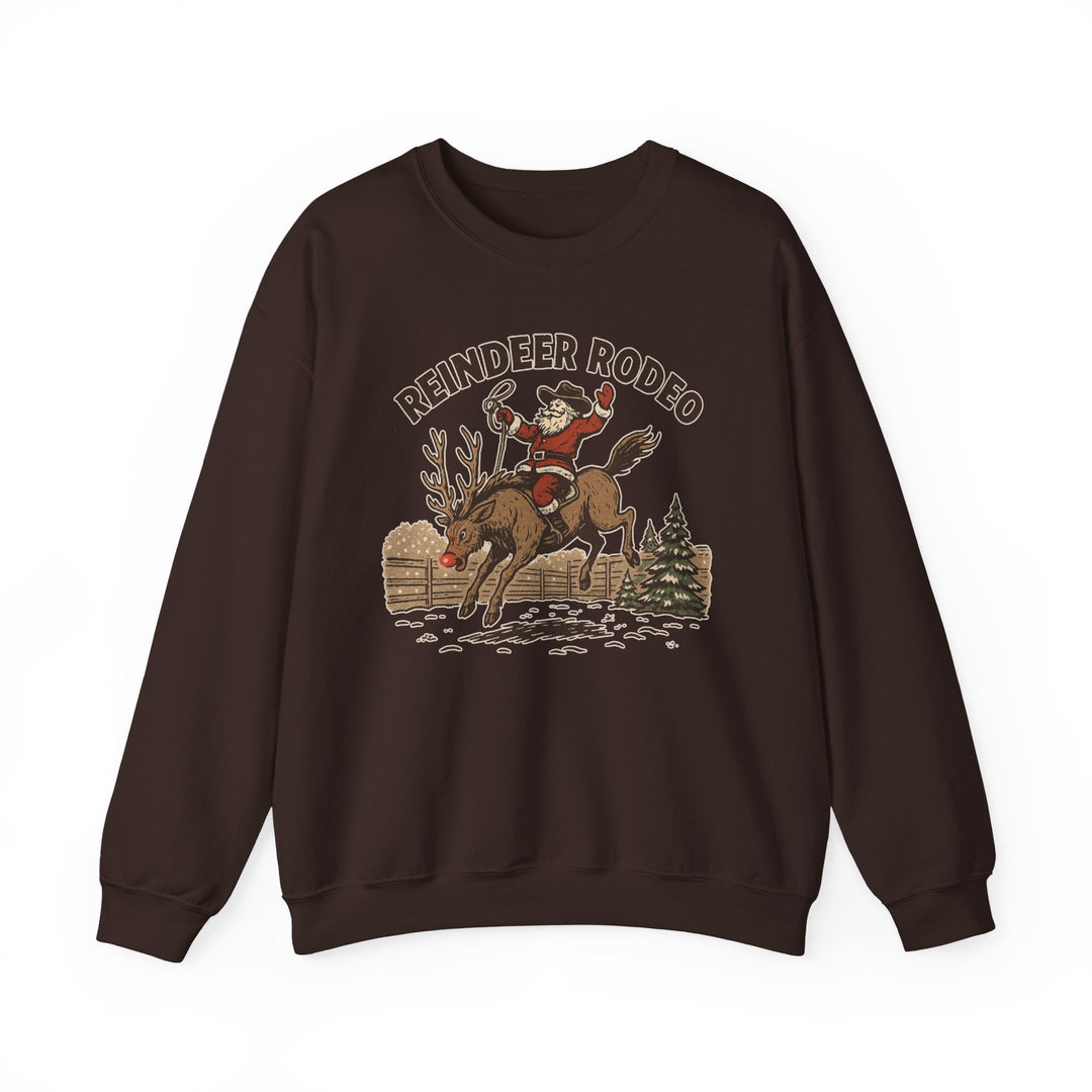Reindeer Rodeo Crew sweatshirt featuring Santa in cowboy gear on a bucking reindeer, set against a festive western scene. Ideal for cozy holiday wear.